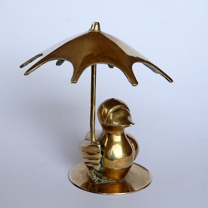 brass duck with umbrella