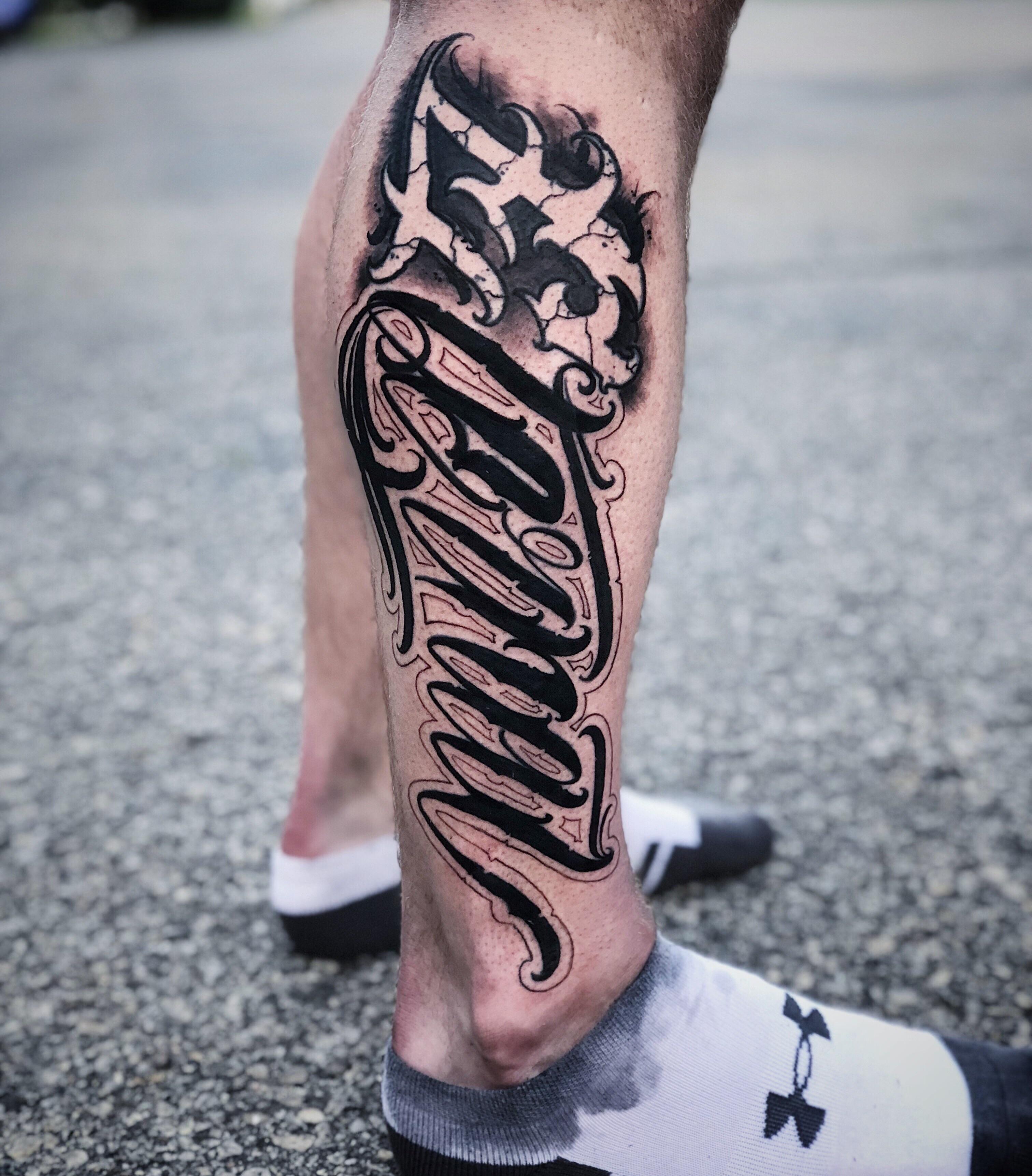 lettering tattoo leg