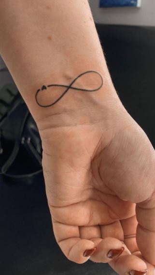 infinity sign tattoo on wrist