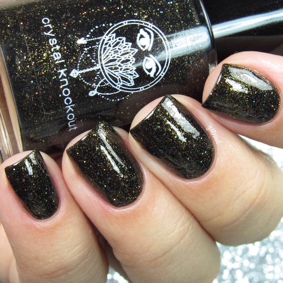 black nail polish with gold glitter