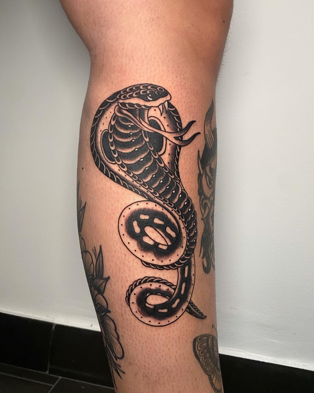 cobra tattoo on leg
