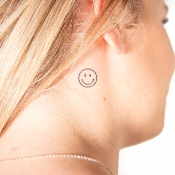 smiling face tattoo